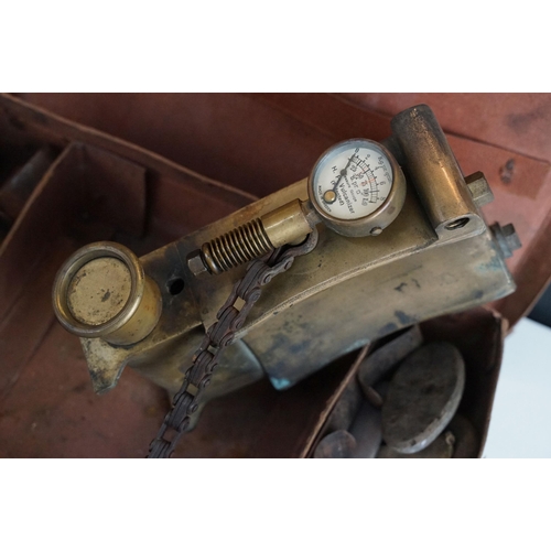 426 - Small leather case containing antique car accessories to include a car vulcaniser with gauge, tax di... 