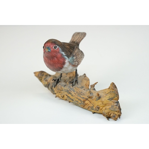 45 - Bird figurines to include Song Thrush and English Robin on wooden branch examples, signed to base, t... 