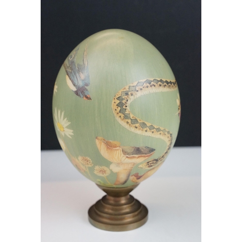 5 - Set of three ceramic hand painted decorative eggs on stands with bird, snakes and wildlife design, t... 