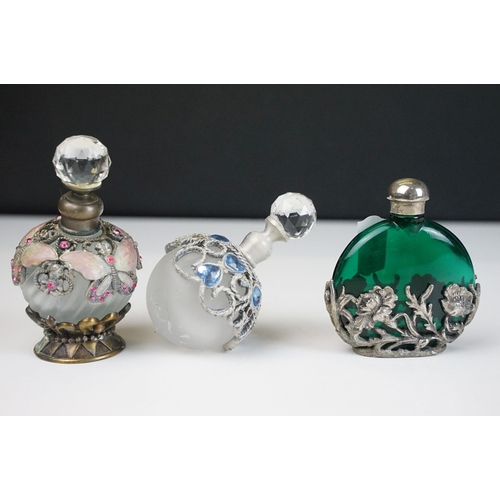 78 - Collection of coloured glass paperweights together with an assortment of scent and perfume bottles (... 