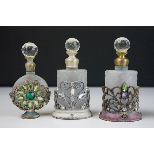 78 - Collection of coloured glass paperweights together with an assortment of scent and perfume bottles (... 