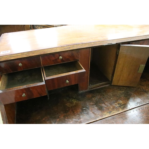 553 - 19th Century oak bureau chest having a bank of four drawers with fold down desk revealing further dr... 