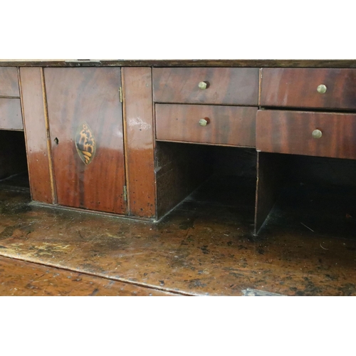 553 - 19th Century oak bureau chest having a bank of four drawers with fold down desk revealing further dr... 