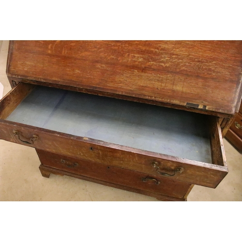 553 - 19th Century oak bureau chest having a bank of four drawers with fold down desk revealing further dr... 