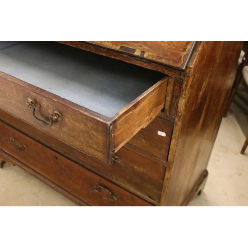 553 - 19th Century oak bureau chest having a bank of four drawers with fold down desk revealing further dr... 