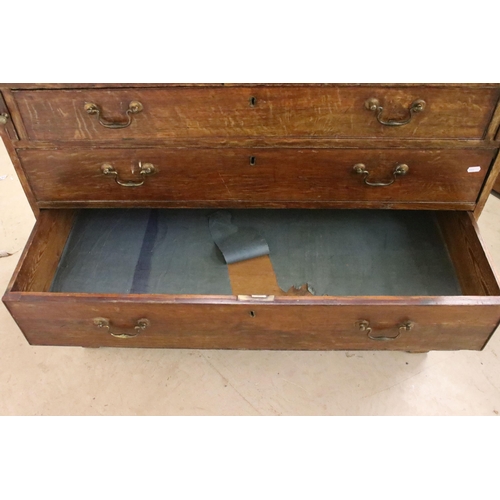 553 - 19th Century oak bureau chest having a bank of four drawers with fold down desk revealing further dr... 