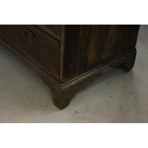 553 - 19th Century oak bureau chest having a bank of four drawers with fold down desk revealing further dr... 