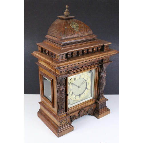 102 - Early 20th century cased architectural mantel clock with two carved maiden figureheads, glass sides,... 