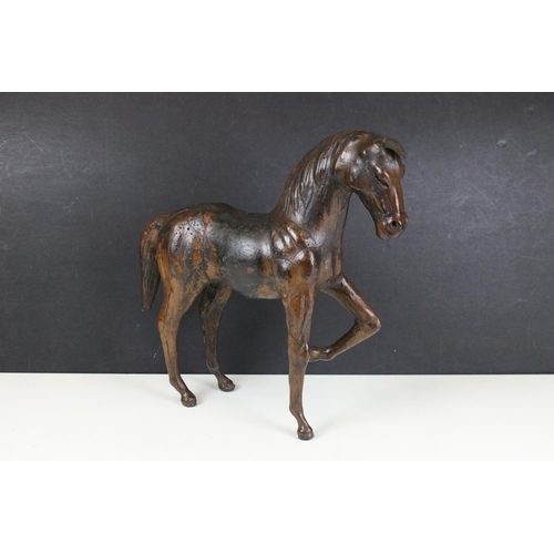 114 - Pair of leather Liberty style covered model horses with glass eyes, tallest H 33.5cm