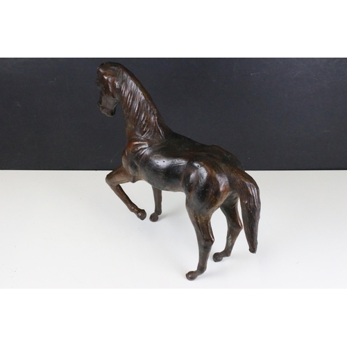 114 - Pair of leather Liberty style covered model horses with glass eyes, tallest H 33.5cm