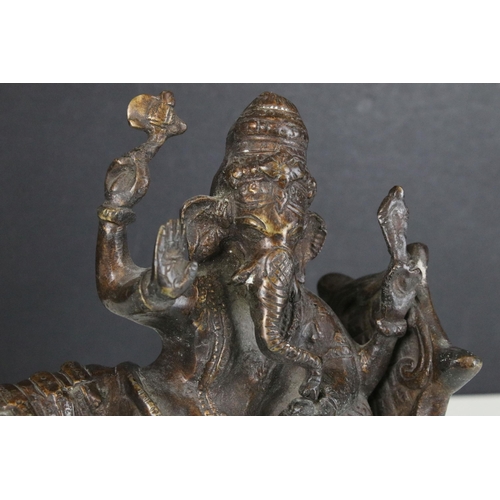 134 - Bronze four armed Ganesh on couch, H 20cm