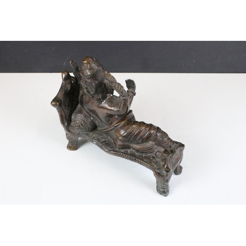 134 - Bronze four armed Ganesh on couch, H 20cm