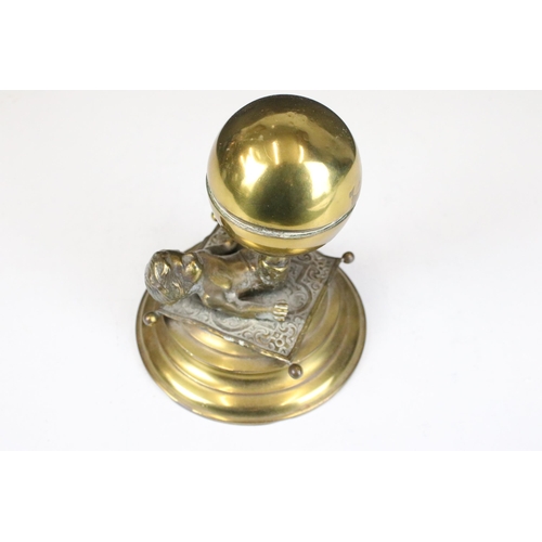 137 - Brass boy and ball on carpet inkwell on stand, H 14cm