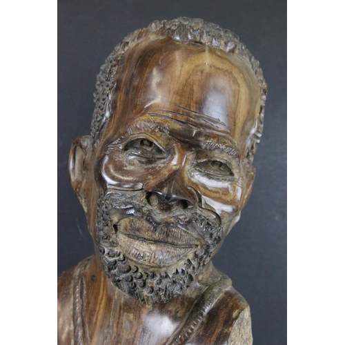 143 - African carved hardwood bust of a native African man, wearing a necklace, 36cm high