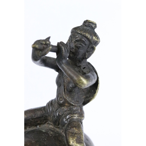 182 - A Chinese cast bronze / brass metal ornamental figure of a ox with mounted man playing the flute, st... 