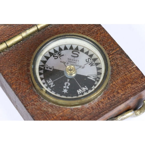 183 - An early to mid 20th century brass cased pocket compass set within a wooden box together with leathe... 