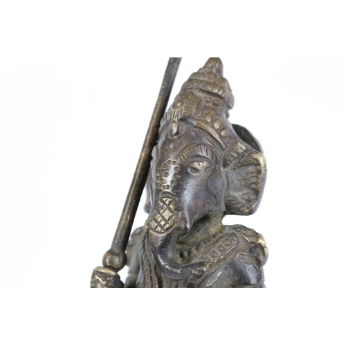 184 - An Indian cast bronze / brass metal ornamental figure of Hindu elephant god Ganesha holding umbrella... 