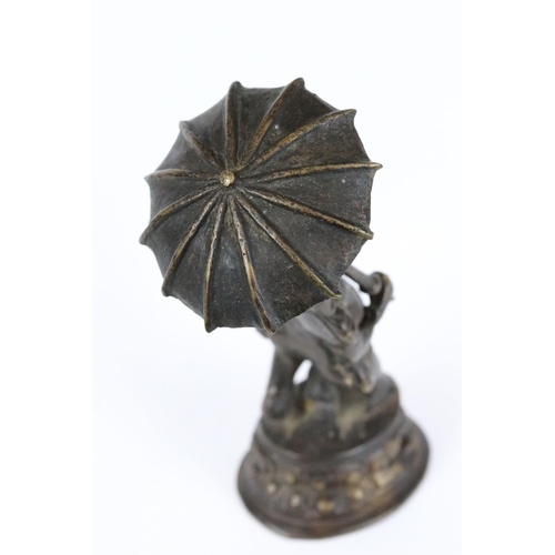 184 - An Indian cast bronze / brass metal ornamental figure of Hindu elephant god Ganesha holding umbrella... 