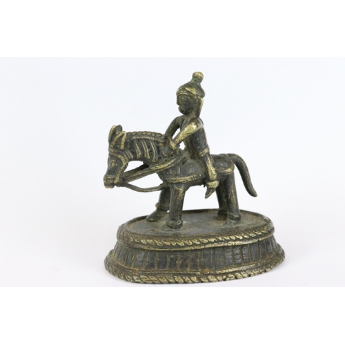 194 - Two Indian bronze / brass ornamental figures to include an ox on plinth and a man of horseback, toge... 