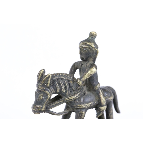 194 - Two Indian bronze / brass ornamental figures to include an ox on plinth and a man of horseback, toge... 