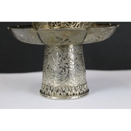 202 - A Chinese / Tibetan silver / white metal cup stand and lid with fine chased decoration, stands appro... 