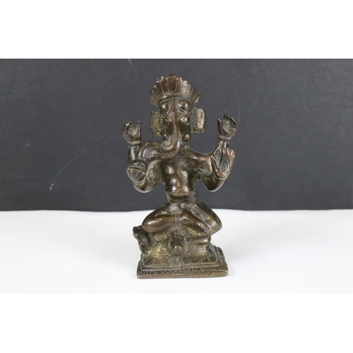 204 - A collection of three Indian cast metal Hindu elephant god Ganesha ornamental figures, largest stand... 