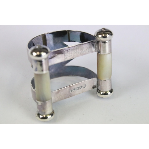 210 - A fully hallmarked sterling silver napkin ring with cylindrical mother of pearl to base, assay marke... 