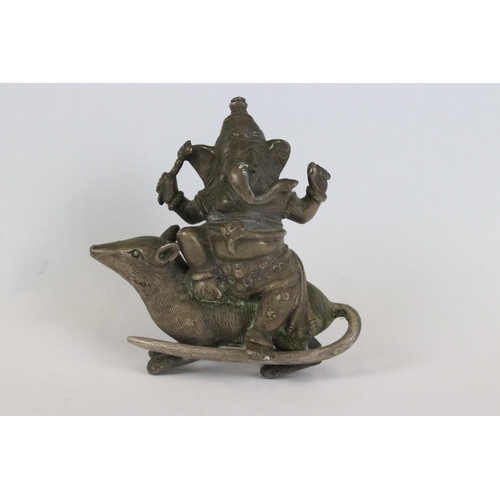 217 - A group of three Indian cast metal ornamental statues to include the elephant god Ganesha sat upon a... 