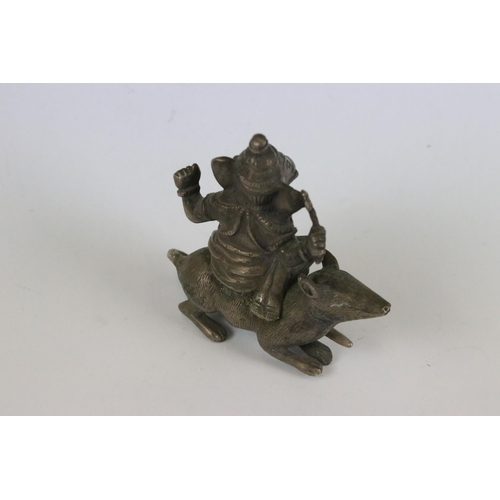 217 - A group of three Indian cast metal ornamental statues to include the elephant god Ganesha sat upon a... 