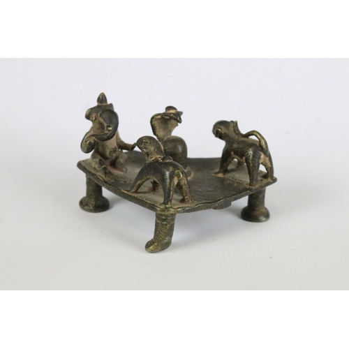 217 - A group of three Indian cast metal ornamental statues to include the elephant god Ganesha sat upon a... 