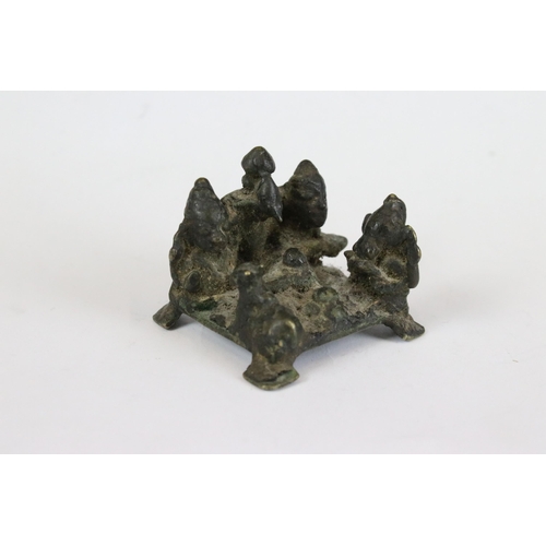 217 - A group of three Indian cast metal ornamental statues to include the elephant god Ganesha sat upon a... 