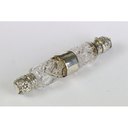 222 - Two antique double ended cut glass scent bottles with hallmarked sterling silver lids and mounts.