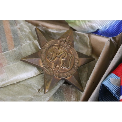 228 - A collection of three sets of full size British World War Two medal groups, all complete with associ... 