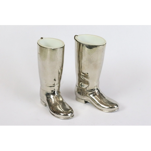 233 - A pair of silver plated stirrup cups in the form of riding boots together with a Isambart Marc Brune... 