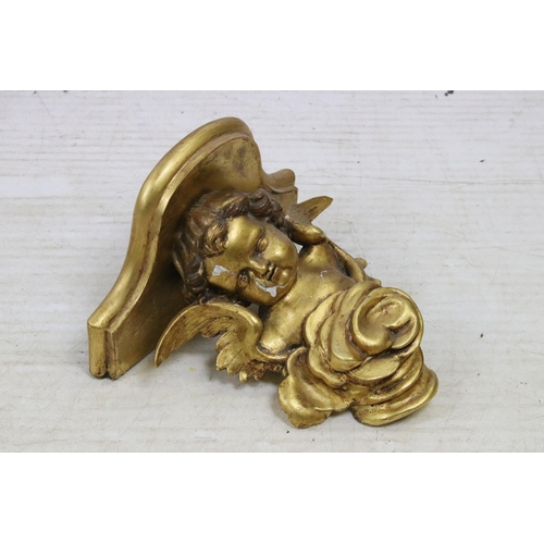 589 - Gilt wood carved cherub with rose wall bracket shelf, H 25, W 26cm, D 17cm