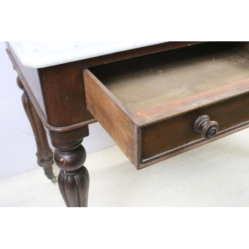 595 - Mahogany and marble washstand server table with two drawers, raised on reeded fluted legs and castor... 