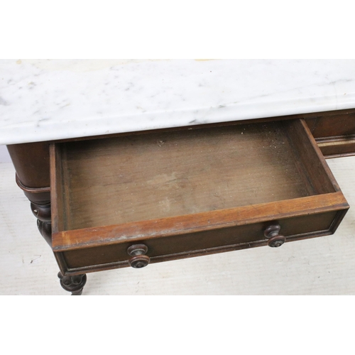 595 - Mahogany and marble washstand server table with two drawers, raised on reeded fluted legs and castor... 