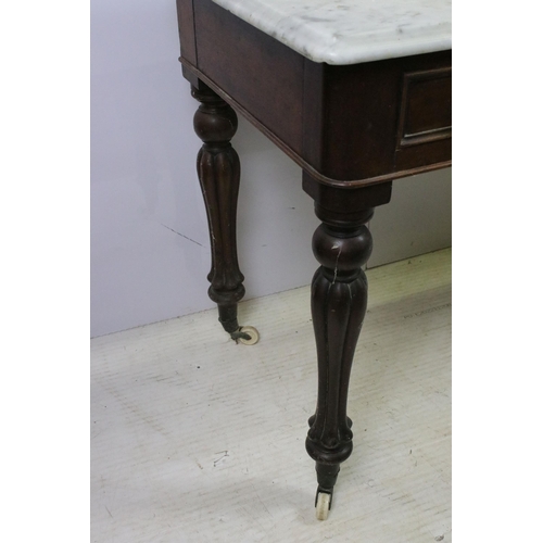 595 - Mahogany and marble washstand server table with two drawers, raised on reeded fluted legs and castor... 