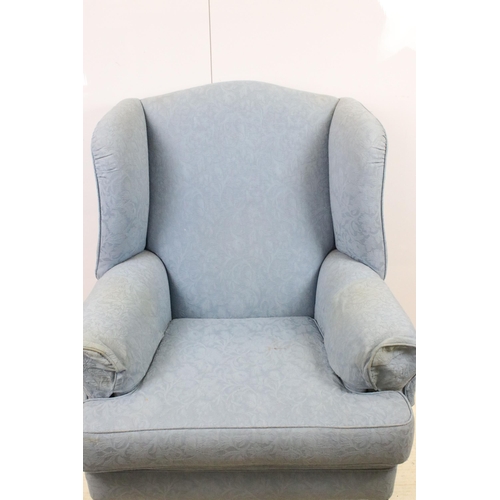 606 - Large wing back armchair raised on square legs, approx. H 105cm