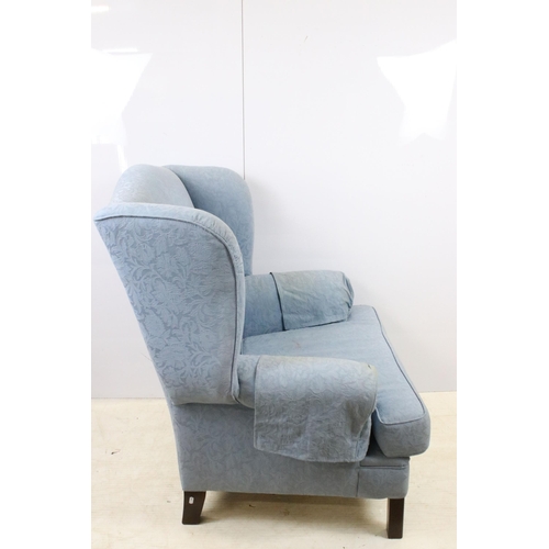 606 - Large wing back armchair raised on square legs, approx. H 105cm