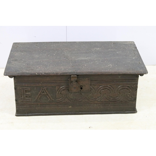 609 - 17th century oak bible box with hinged lid above a carved front bearing initials AE, H 22cm, W 64cm,... 