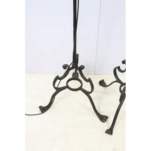 612 - Pair of wrought iron scroll tripod base floor lamps with old deed type fringed lamp shades, H 176cm