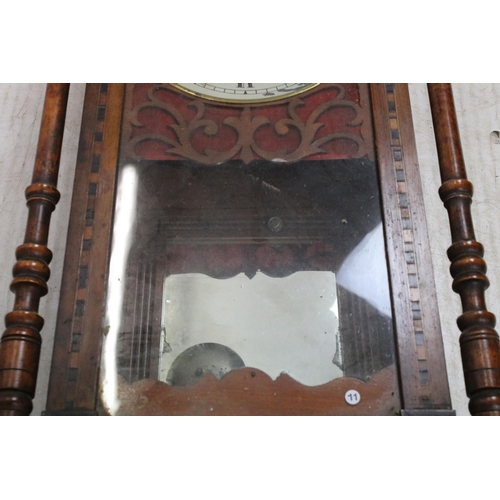 645 - Antique marquetry bordered case clock with hand carved pediment, fret work around dial, turned pilla... 