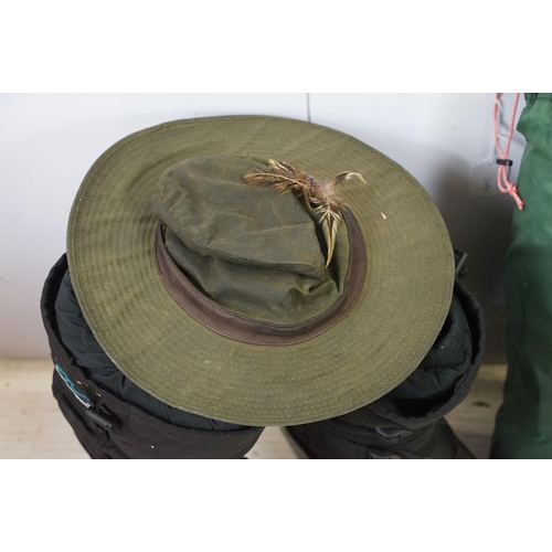 425A - Barbour waterproof hat Size L, together with a Outback hat with badges, Integral Design's Goose down... 