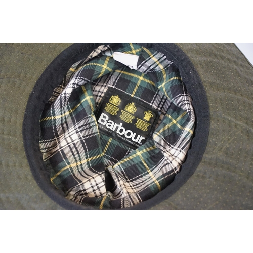 425A - Barbour waterproof hat Size L, together with a Outback hat with badges, Integral Design's Goose down... 