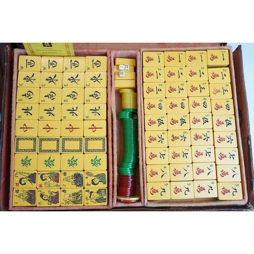 387 - Two boxed Mah Jong game sets, one 1923 version with Bakelite butterscotch tiles together with hand m... 