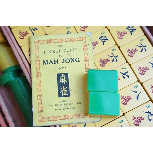 387 - Two boxed Mah Jong game sets, one 1923 version with Bakelite butterscotch tiles together with hand m... 