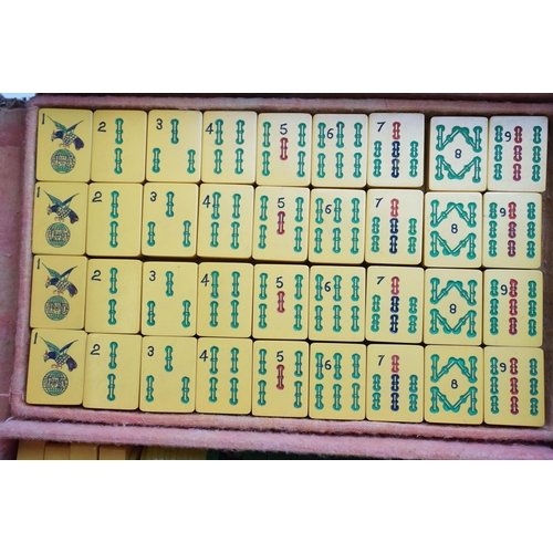 387 - Two boxed Mah Jong game sets, one 1923 version with Bakelite butterscotch tiles together with hand m... 