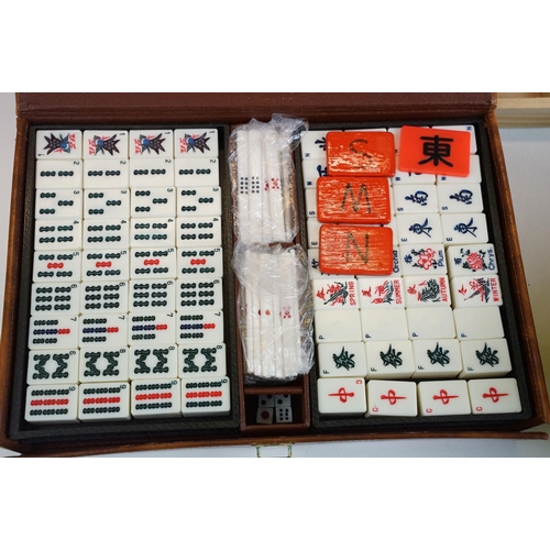 387 - Two boxed Mah Jong game sets, one 1923 version with Bakelite butterscotch tiles together with hand m... 