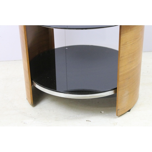 562 - Curved teak side lamp table with black glass top, diameter 61cm